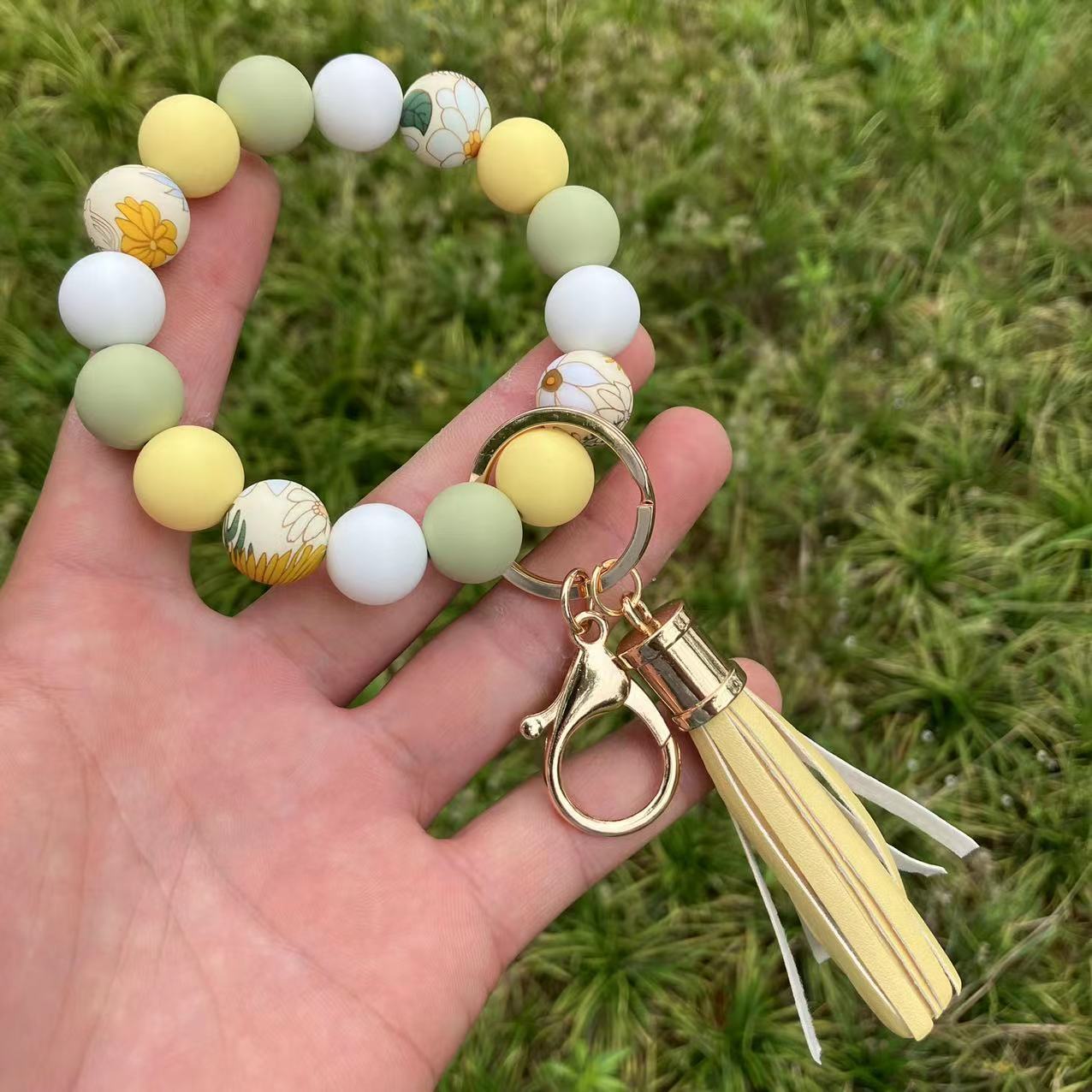 Comercio al por mayor leopardo girasol borla de silicona con cuentas llavero de muñeca